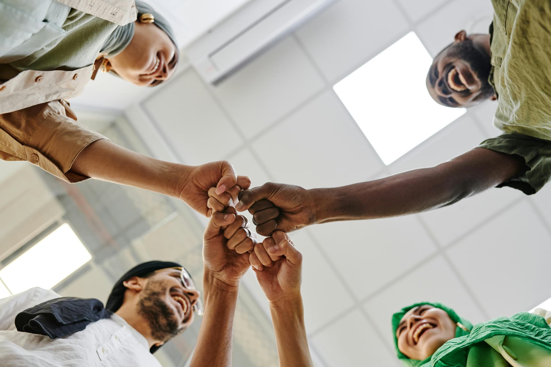group of friends giving each other a fist bump